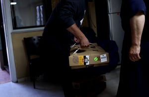 Lifting Box of Frozen Chickens